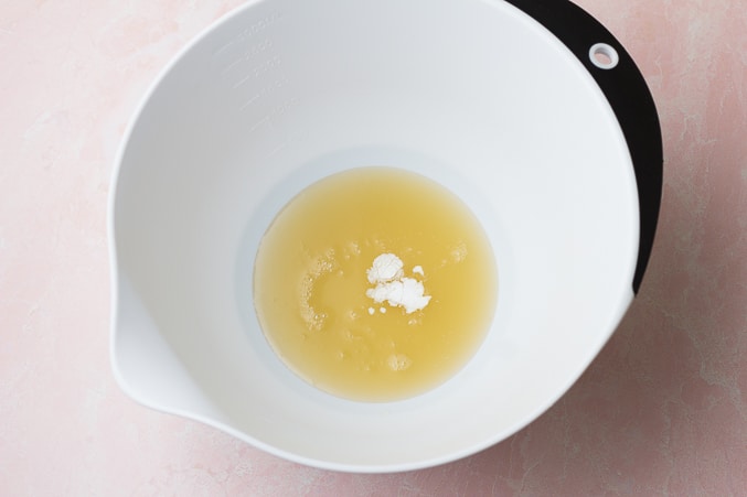 chickpea liquid and cream of tartar in white bowl