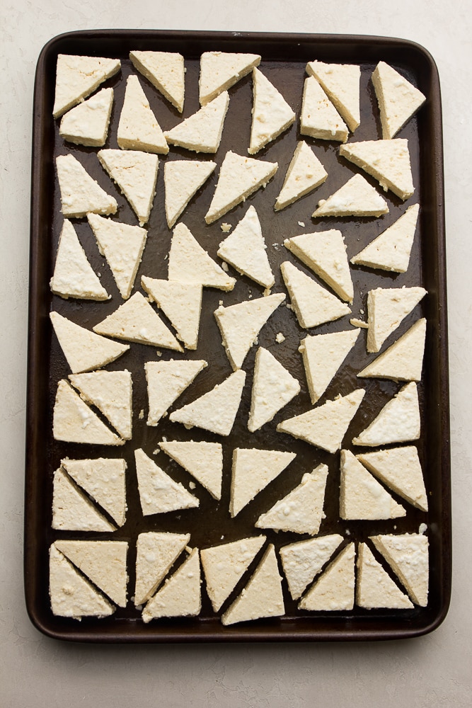 triangle tofu pieces on a sheet pan