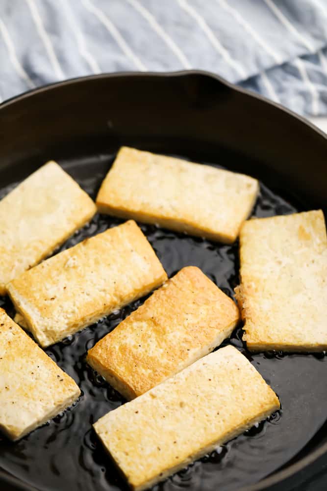 tofu slabs frying in a pan