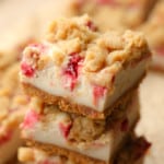 close up on a pile of Vegan Strawberry Cheesecake Crumble Bars.