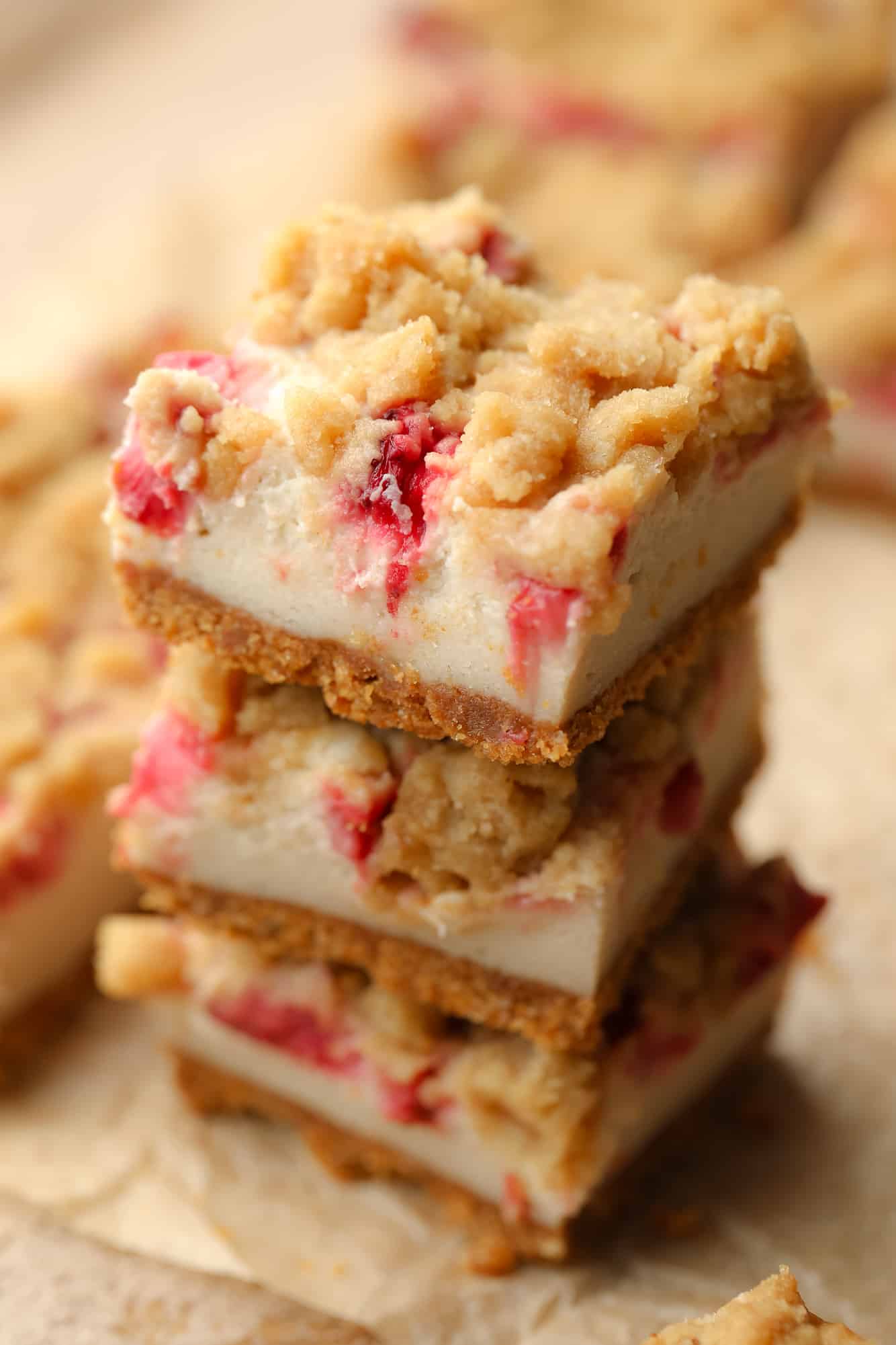 close up on a pile of Vegan Strawberry Cheesecake Crumble Bars.