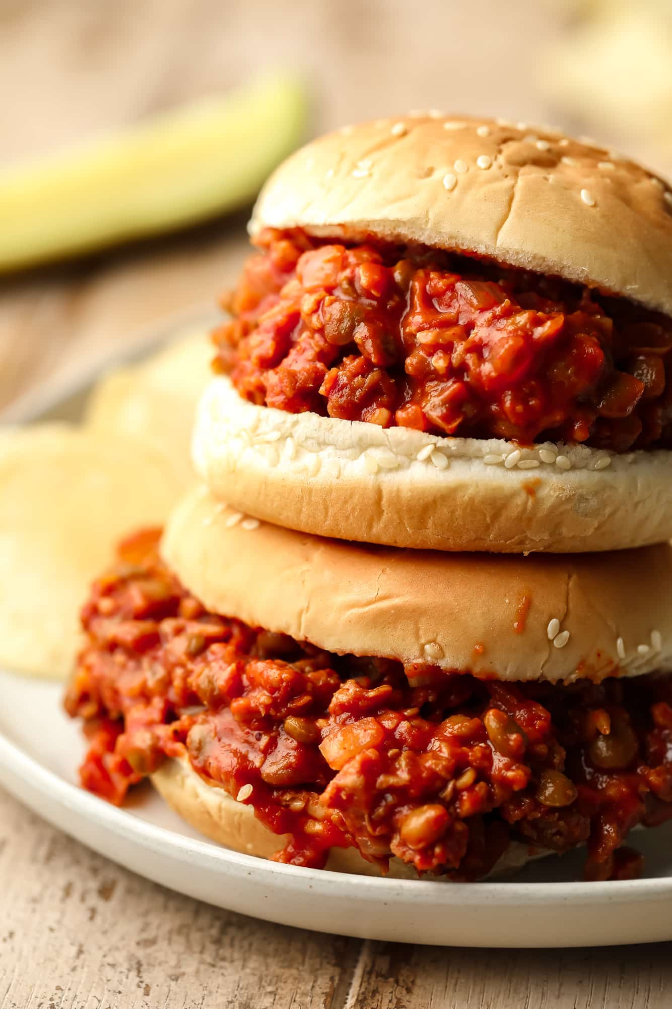 close up on two vegan sloppy joes served in hamburger buns.