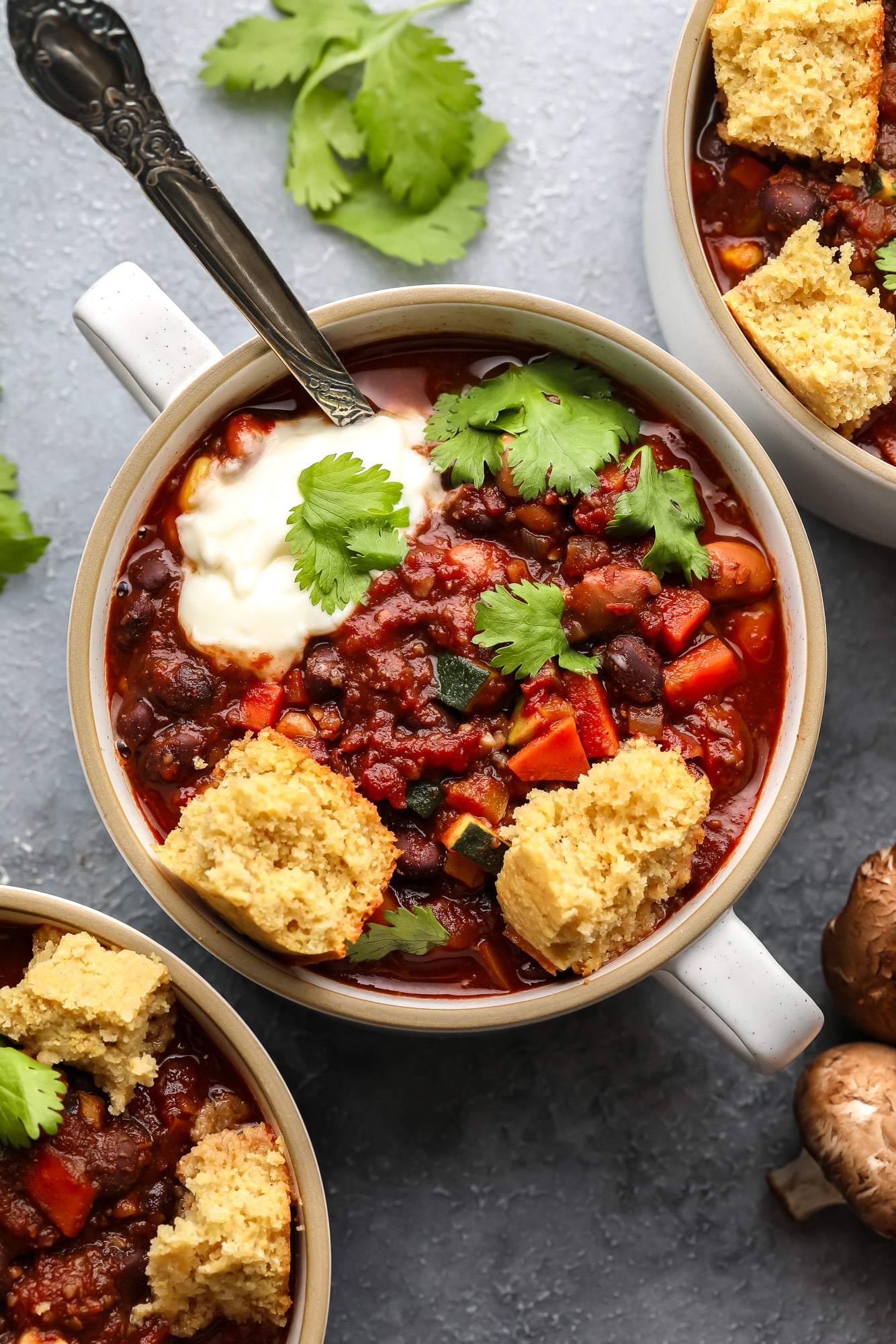 a small bowl of veggie chili topped with vegan cornbread.