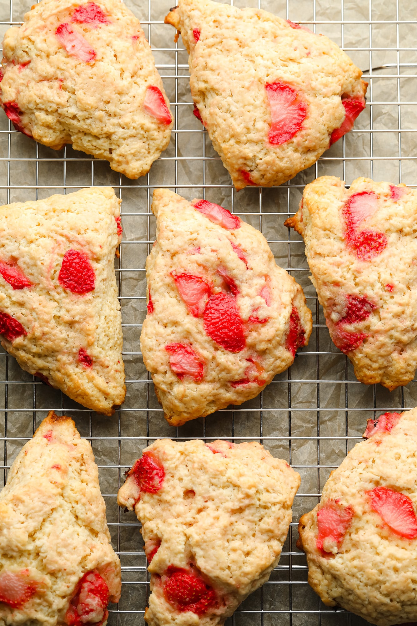 baked vegan strawberry scones on a wire rack.
