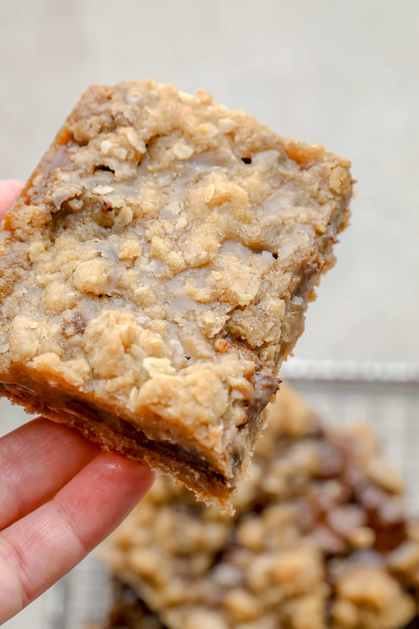 close up on a womans hand holding a Vegan Carmelita.