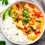 vegan Thai red curry in a white bowl with rice.