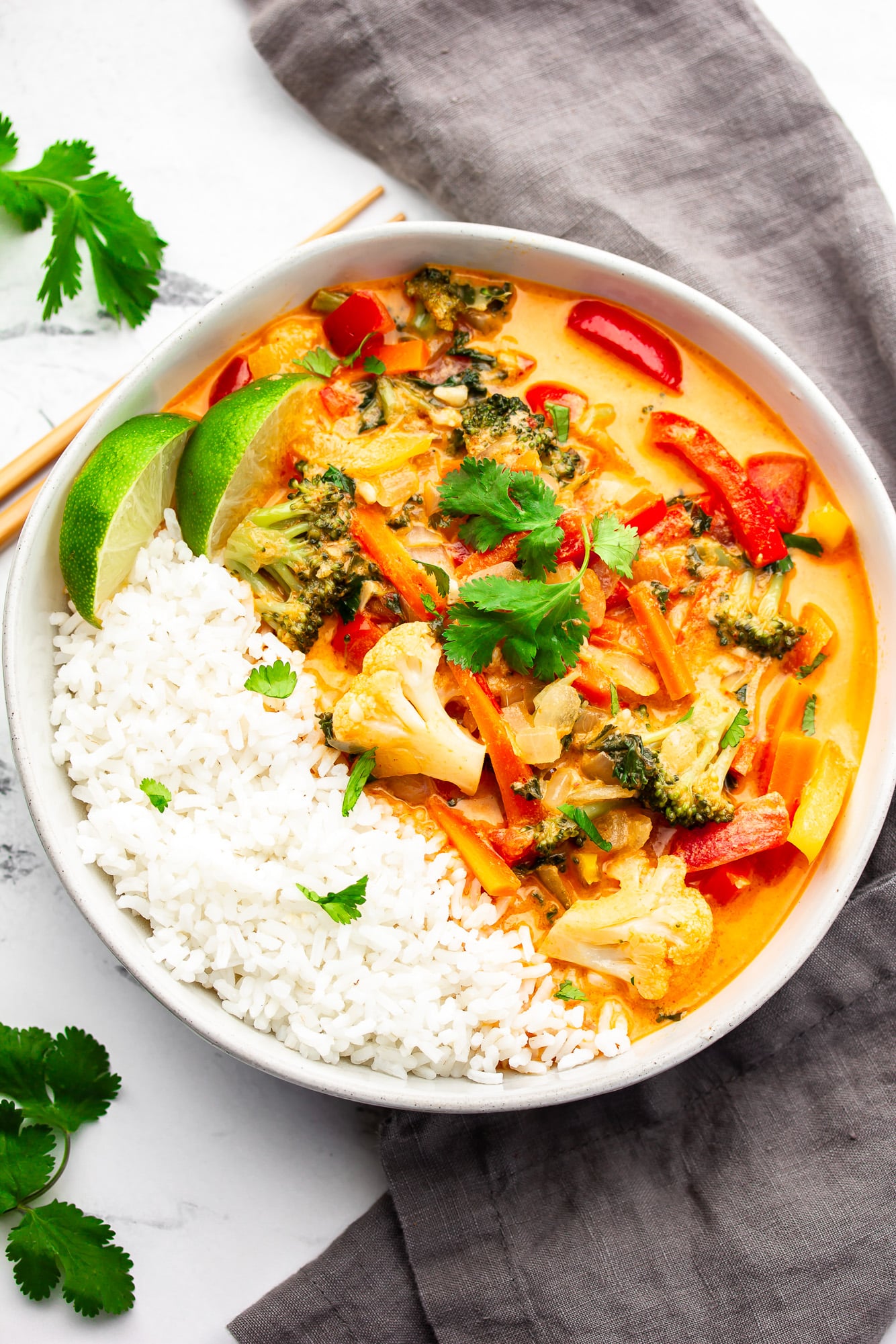 vegan Thai red curry in a white bowl with rice.