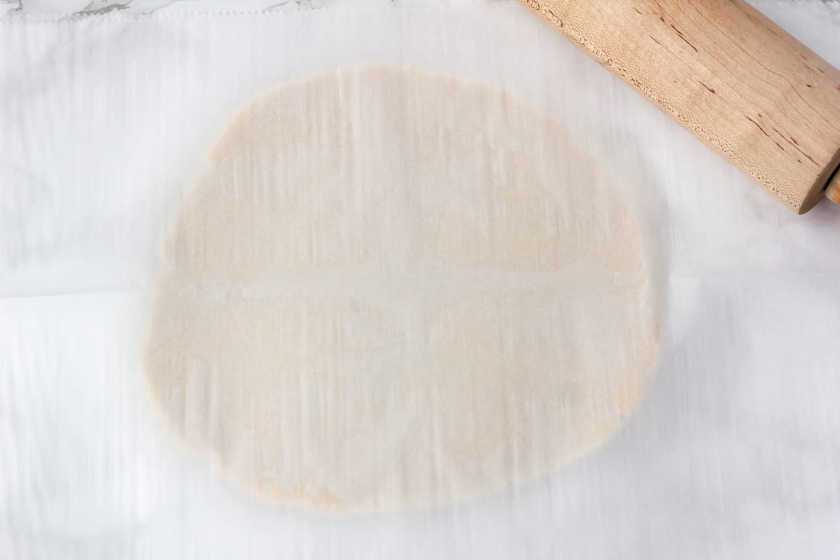 parchment paper covering flat cookie dough