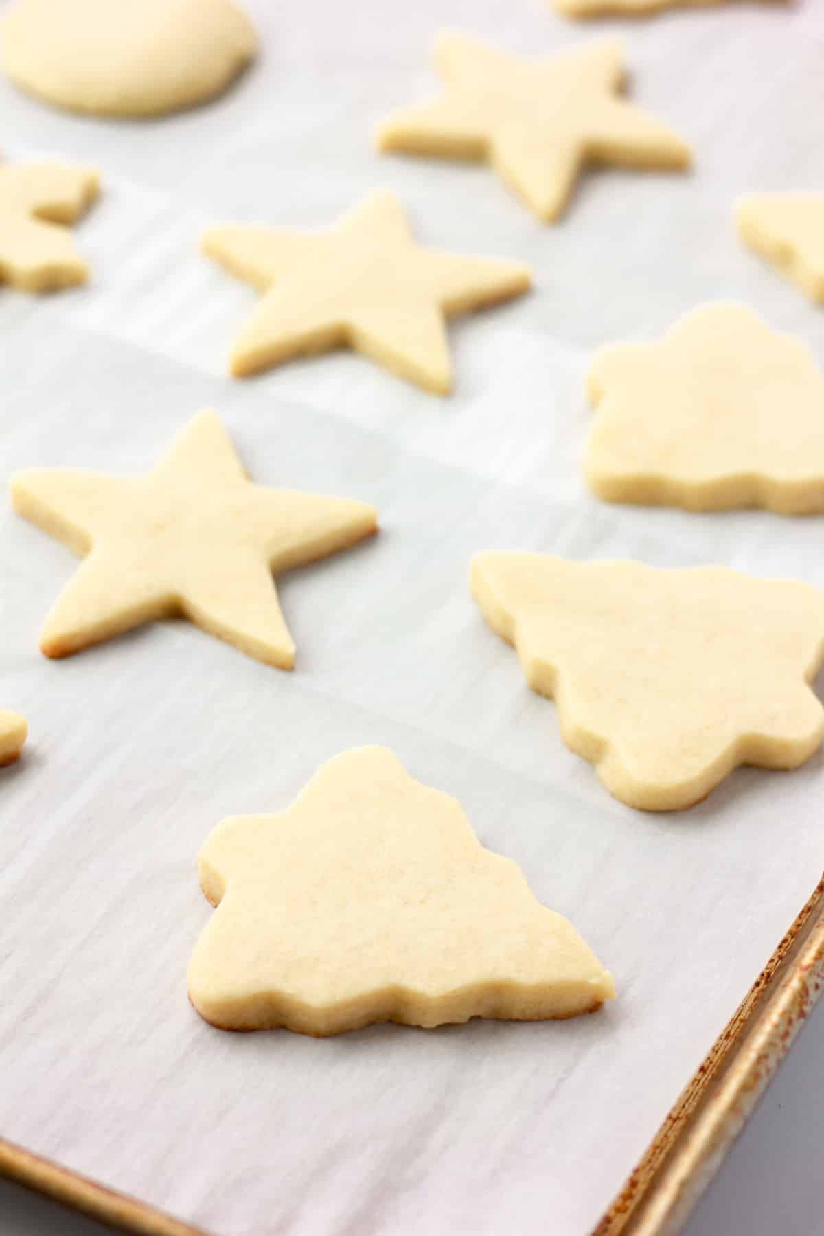 baked sugar cookies on parchment lined pan