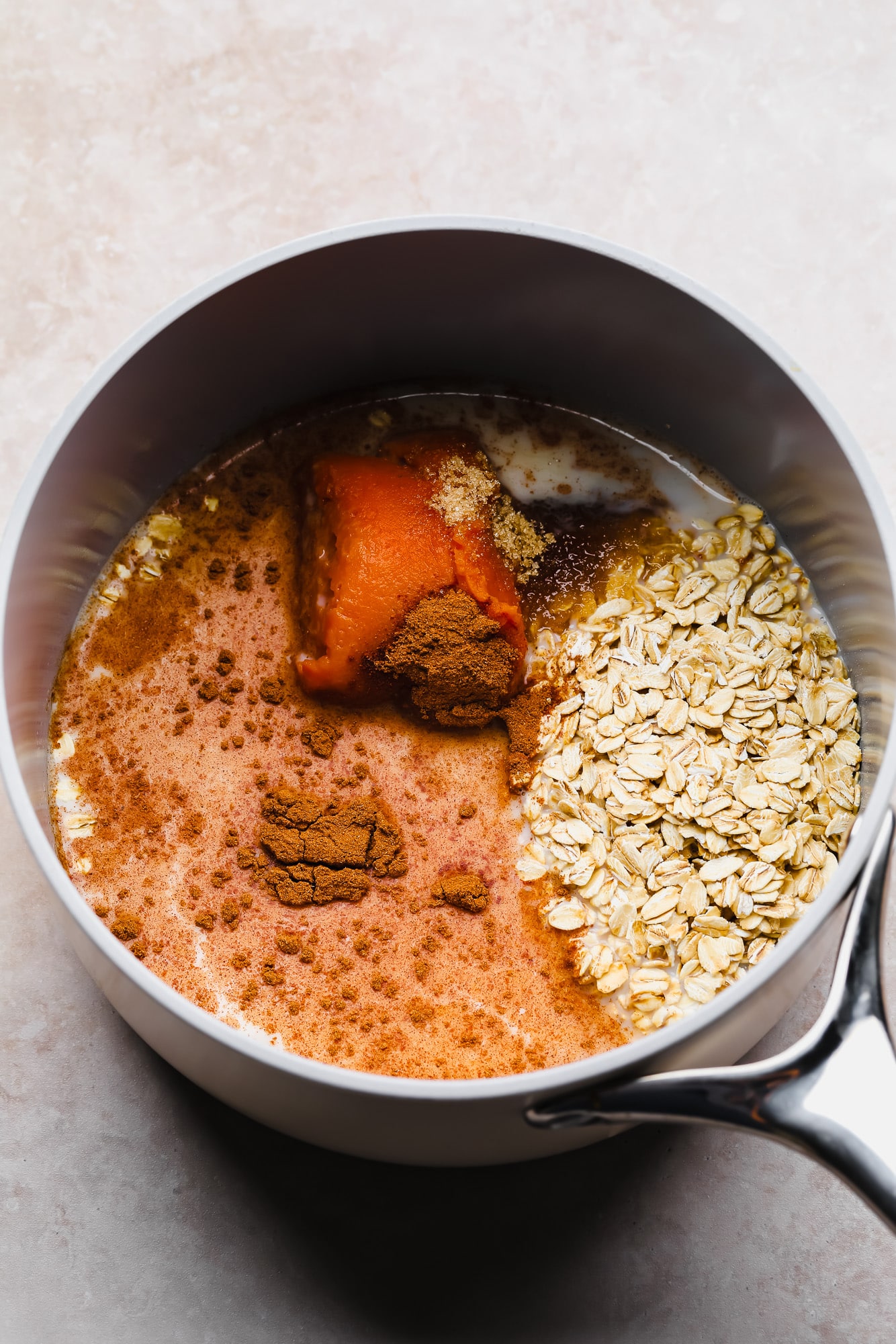 the ingredients for pumpkin oatmeal in a pot.