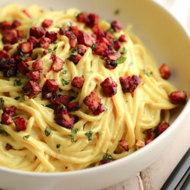 square image of a bowl of vegan carbonara with tofu bacon