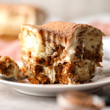 close up on a slice of vegan tiramisu with a bite missing.