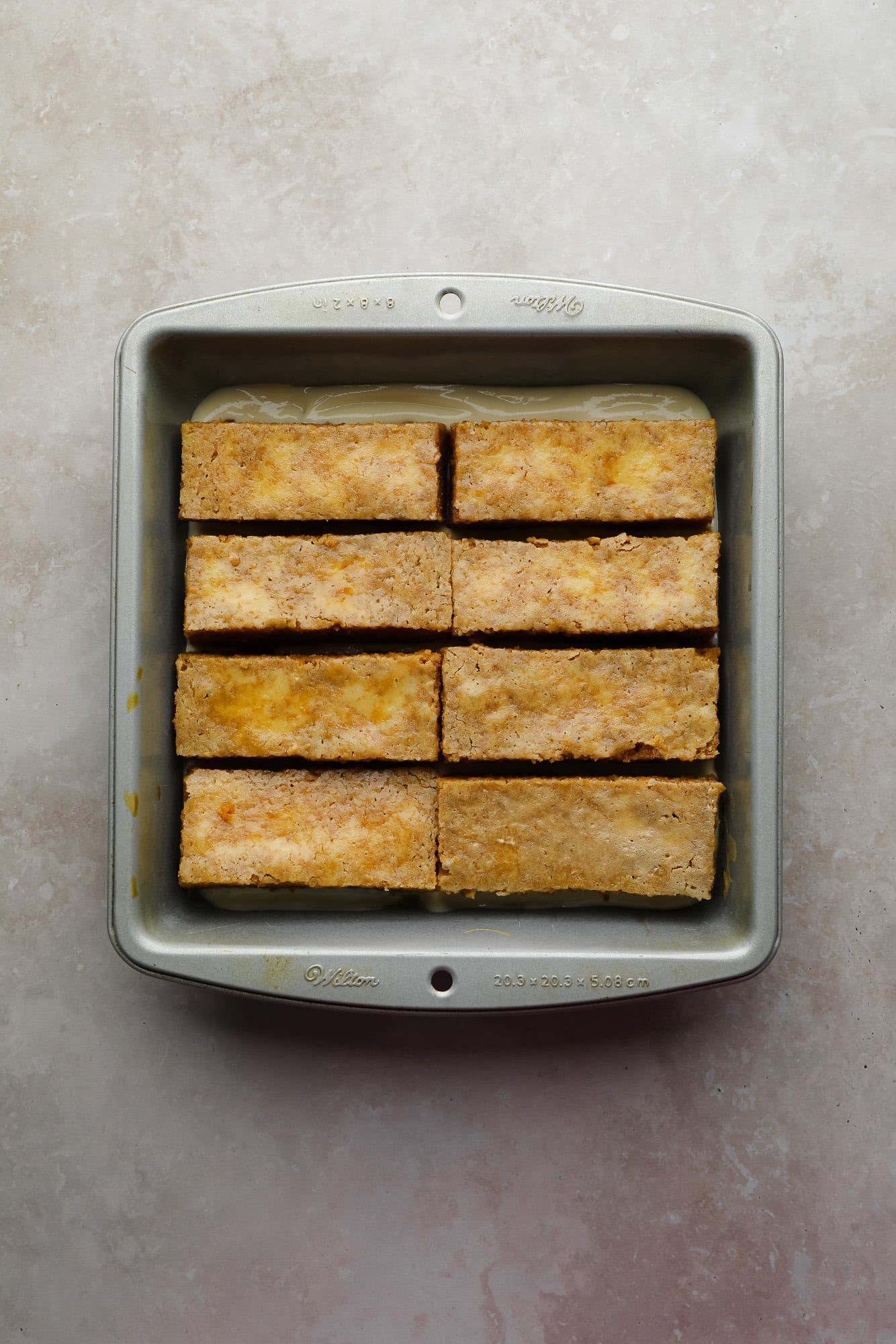 vegan vanilla cake strips soaked in espresso in a baking dish.