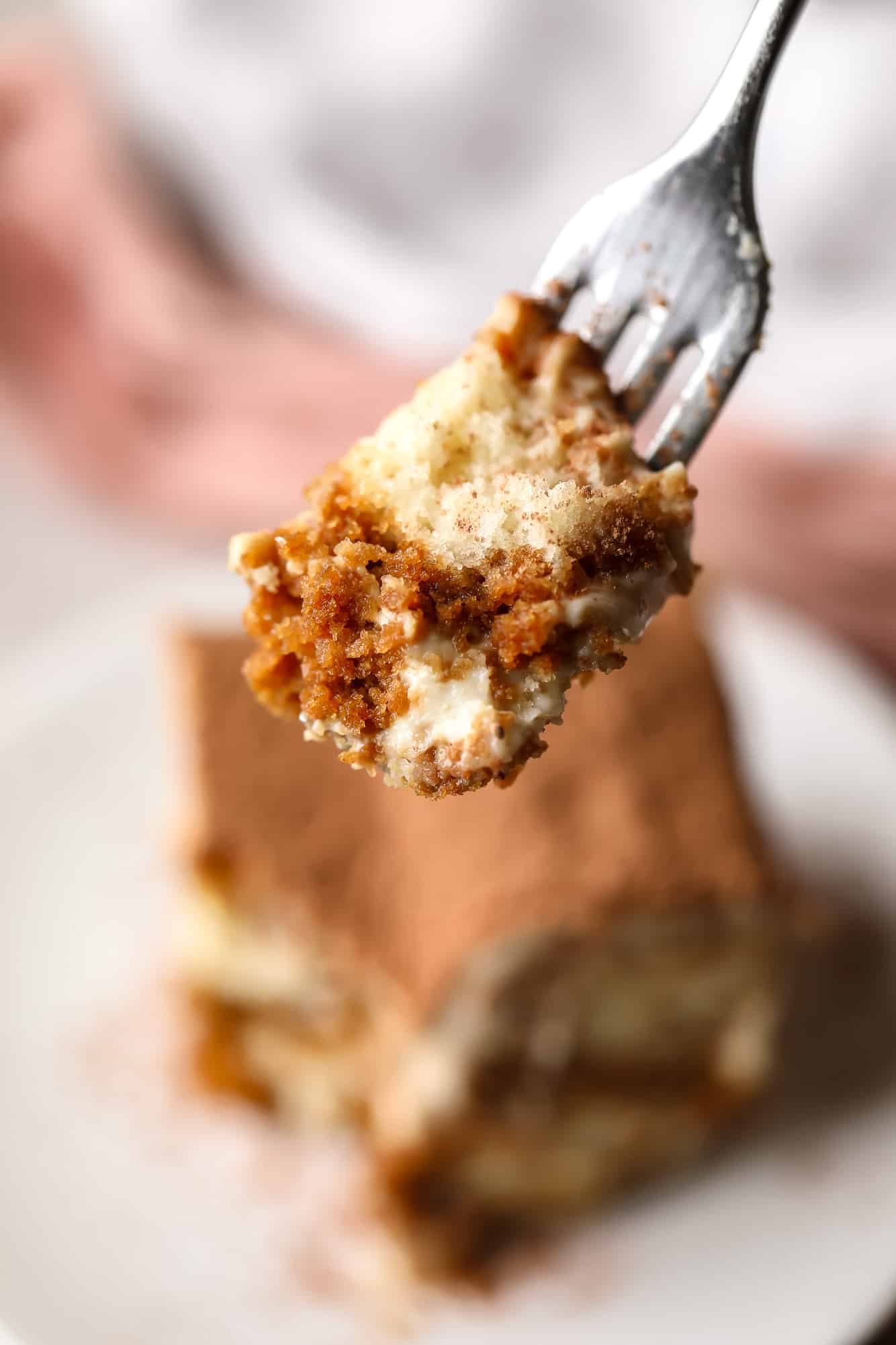 close up on a bite of vegan tiramisu on a fork.