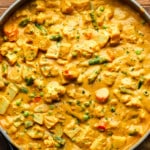 close up on a large pot of golden vegetable korma.