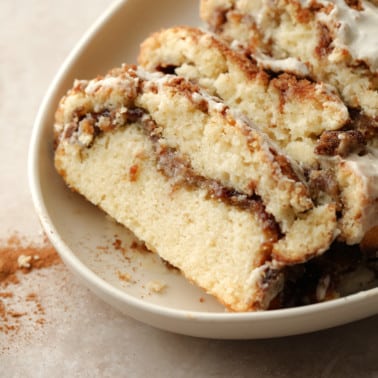 slices of Vegan Cinnamon Swirl Quick Bread on a beige plate.