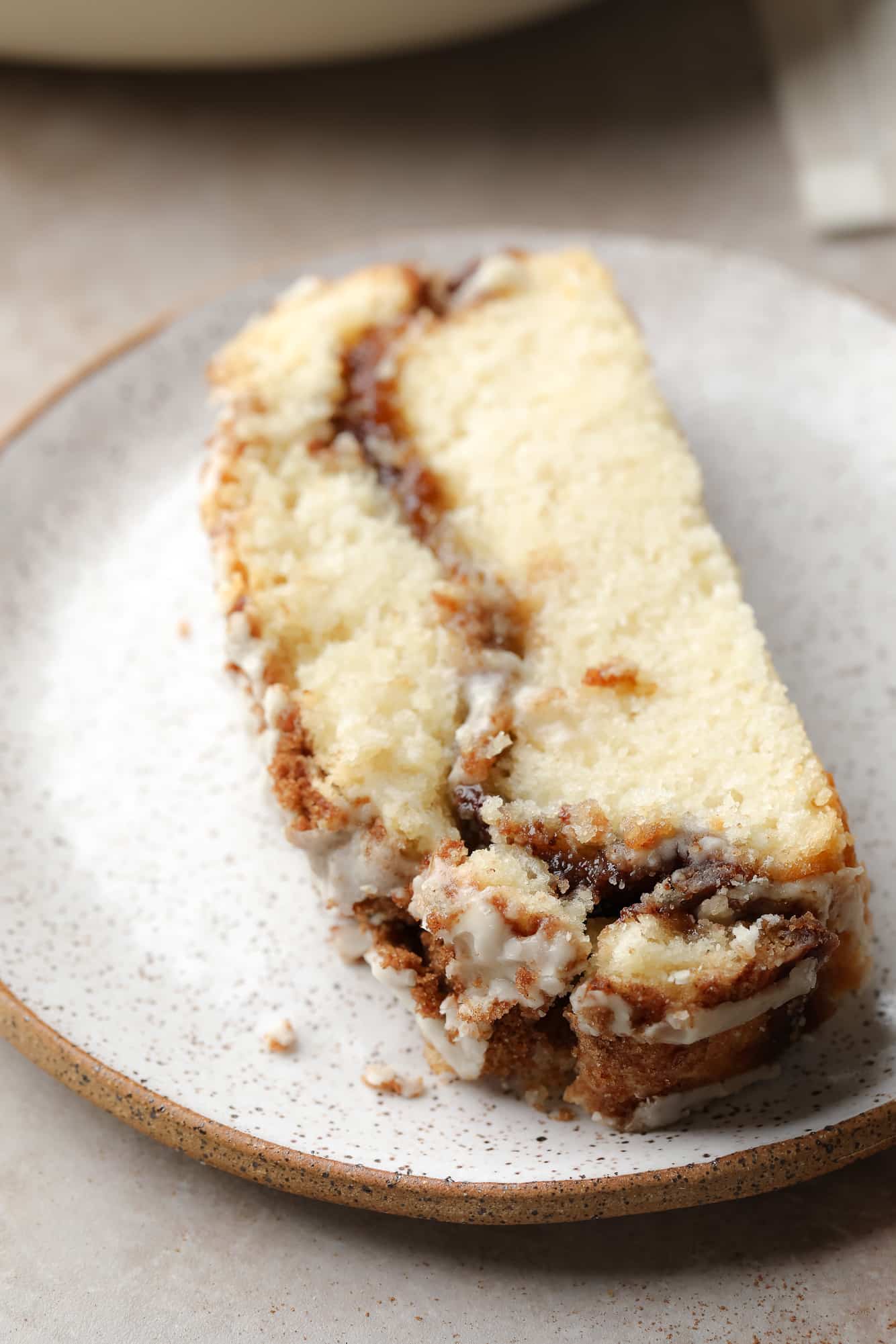 A slice of Vegan Cinnamon Swirl Quick Bread on a white plate.