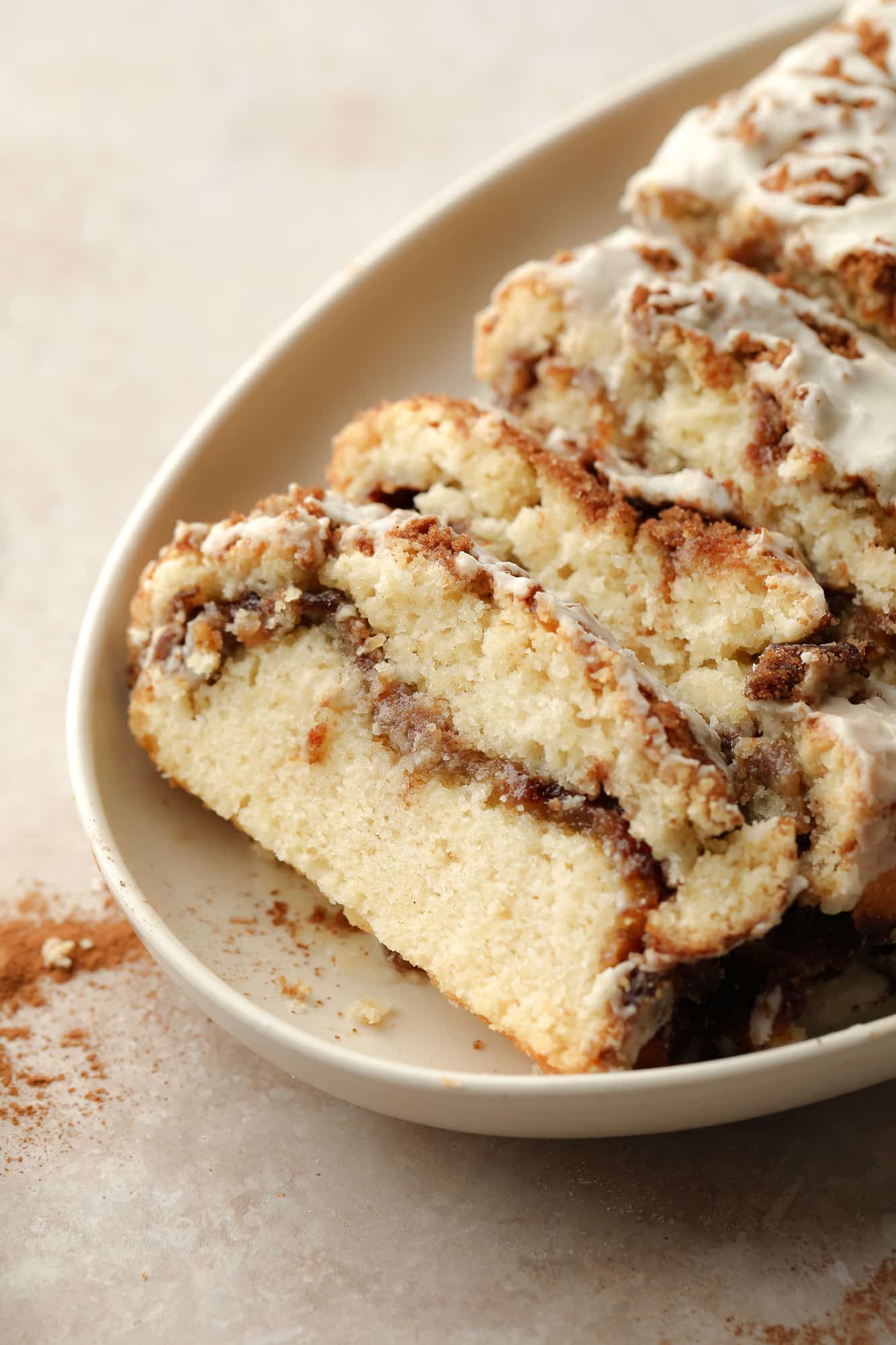 slices of Vegan Cinnamon Swirl Quick Bread on a beige plate.