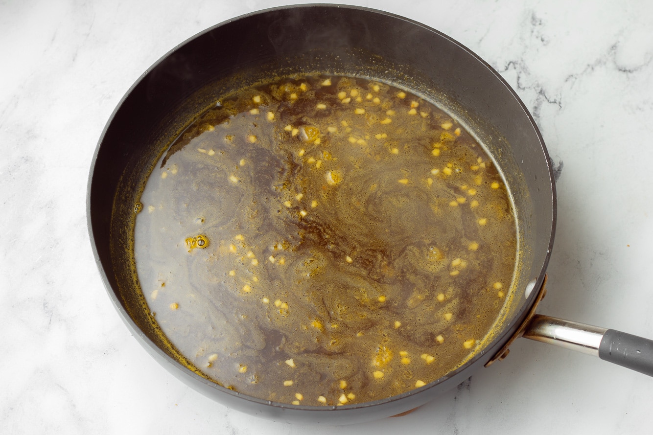 orange sauce for orange tofu in a large black skillet.