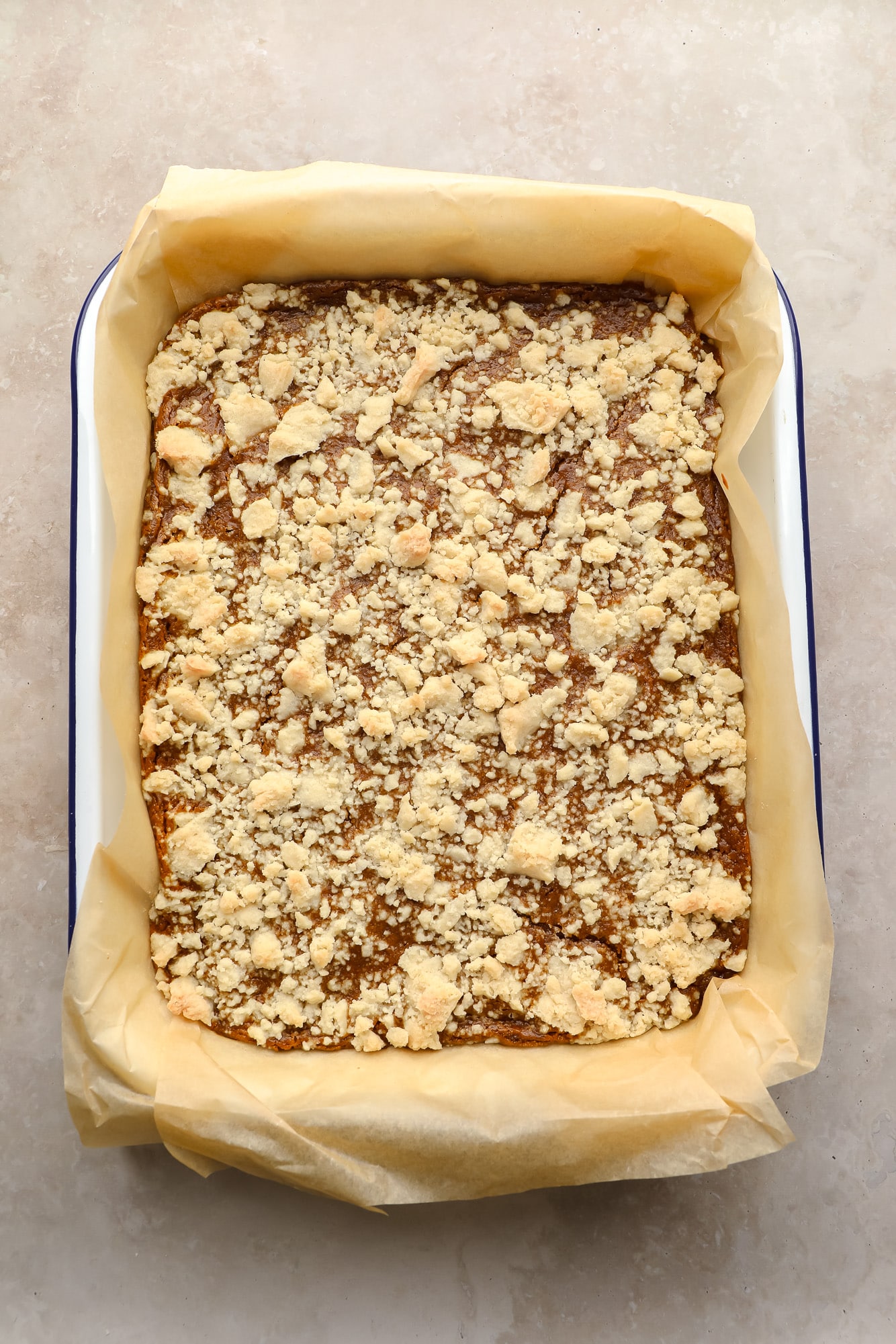 unbaked Vegan Pumpkin Crumble Bars in a baking pan.