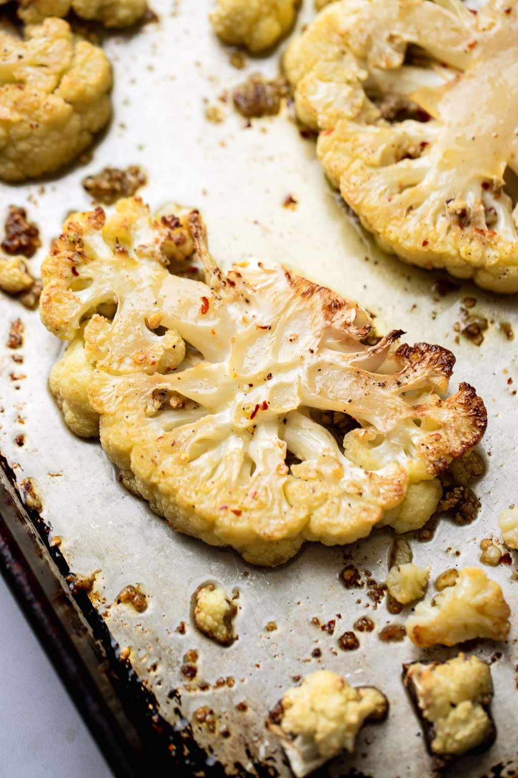 cauliflower steaks roasted on a baking sheet