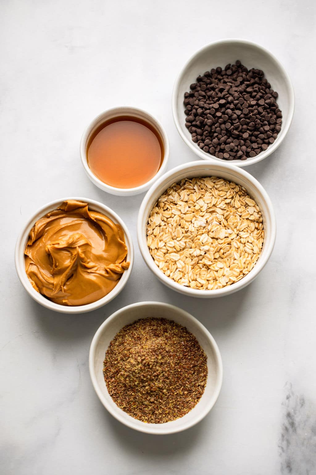 ingredients for Peanut Butter Energy Balls in individual white bowls.