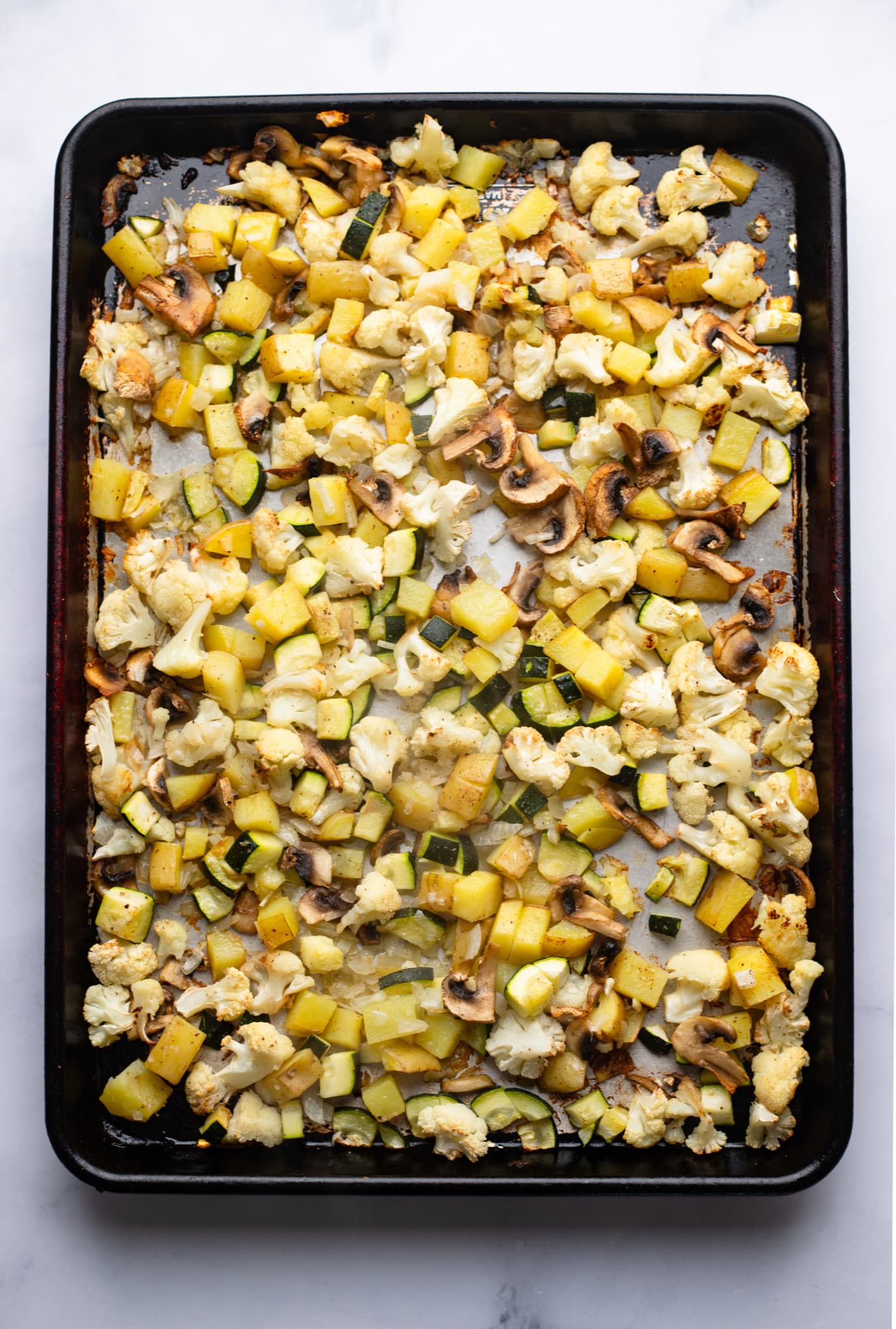 roasted vegetables on a baking sheet.