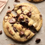 square image of a broken chocolate chip cookie