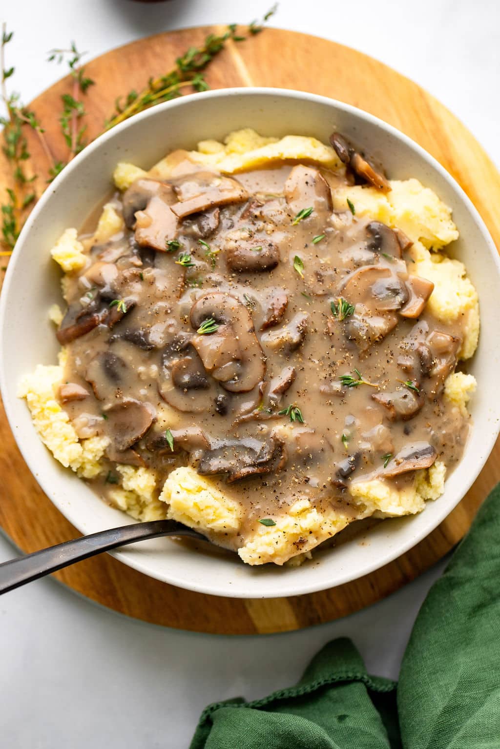 vegan mushroom gravy served over mashed potatoes in a white bowl.