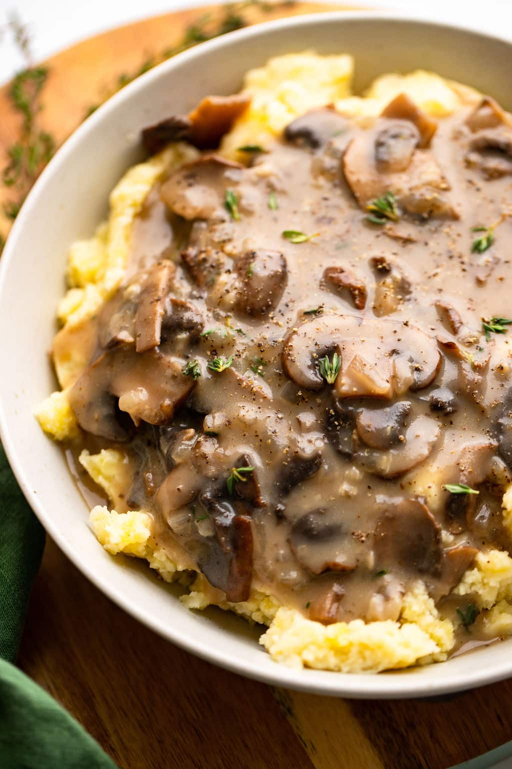 vegan mushroom gravy served over mashed potatoes in a white bowl.