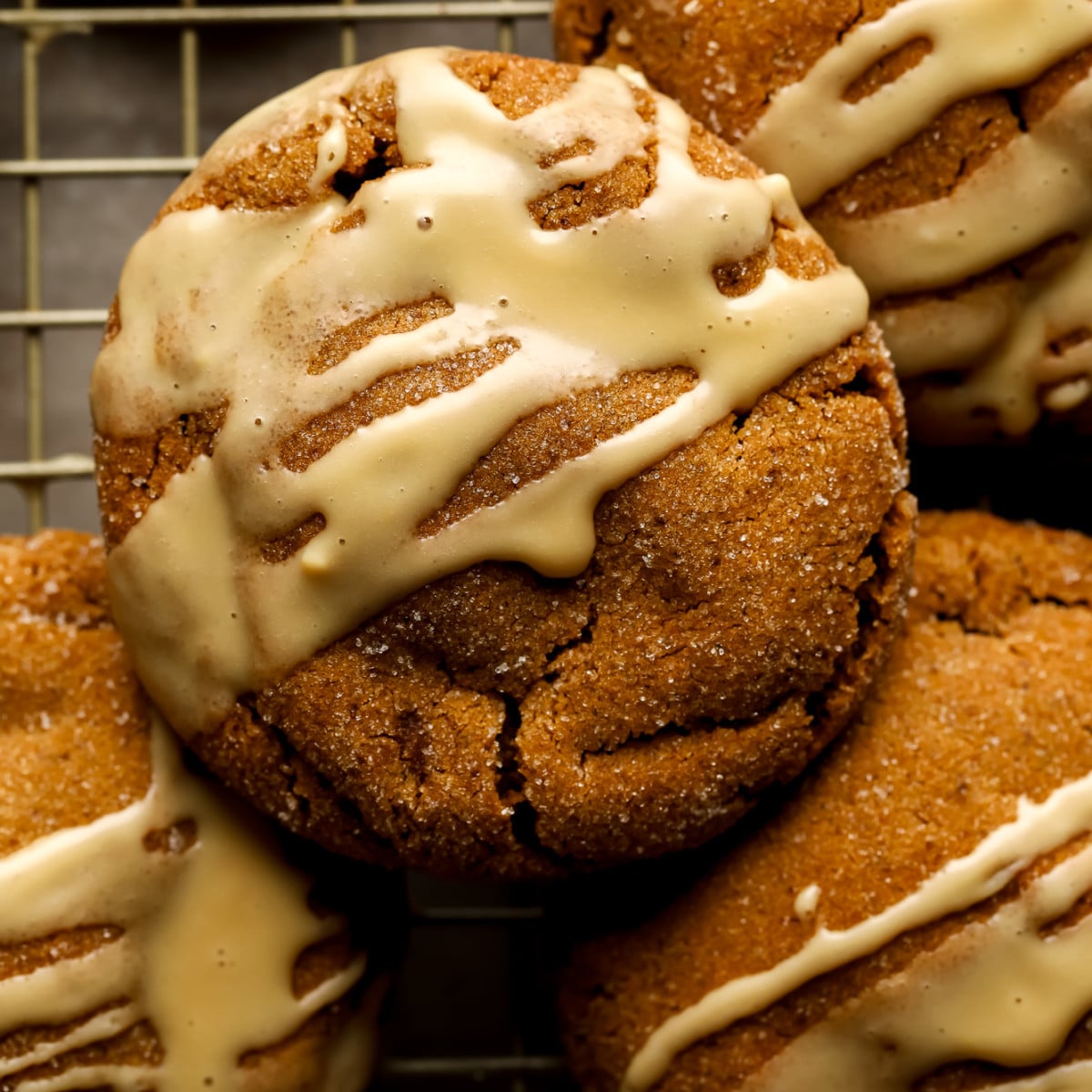 close up on a vegan gingerbread latte cookie drizzled with a white espresso glaze.