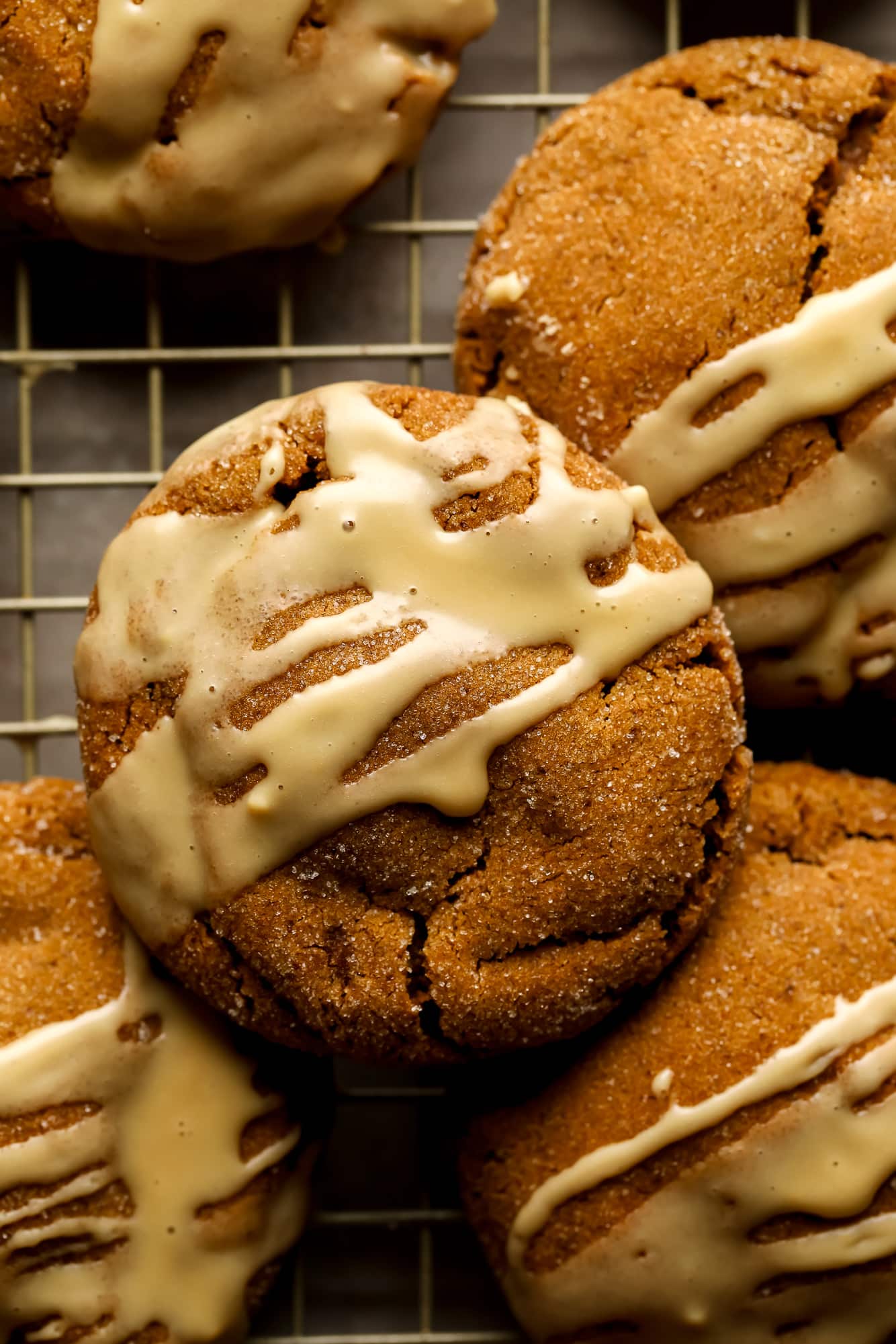 Gingerbread Latte Cookies drizzled with a white espresso glaze on a wire rack.