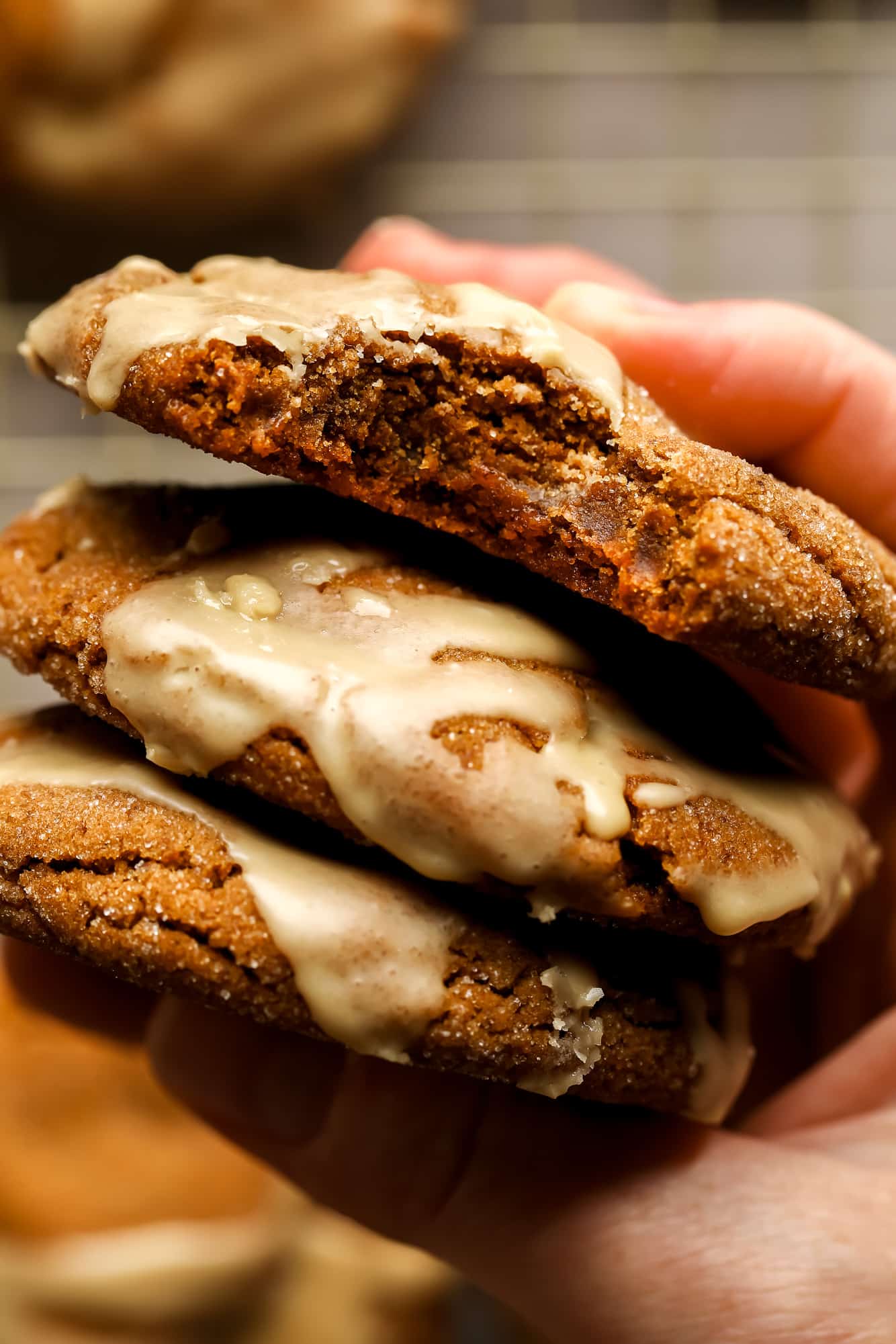 a womans hand holding a stack of Gingerbread Latte Cookies.