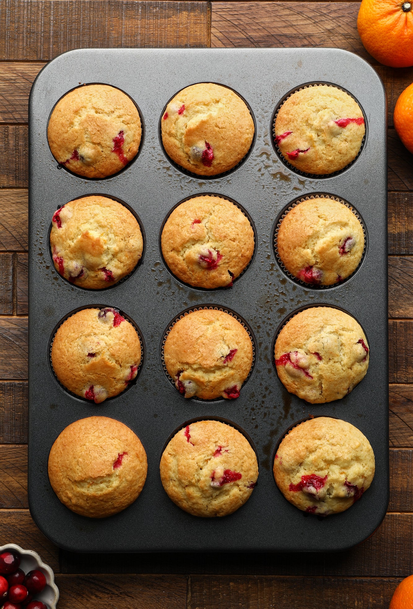 baked Cranberry Orange Muffins in a muffin tin.