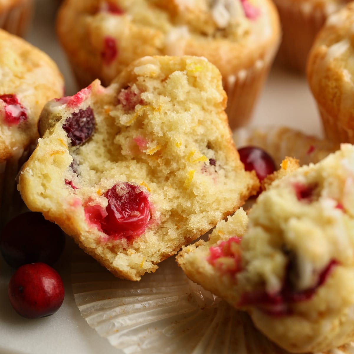 close up on a cranberry orange muffin cut in half.