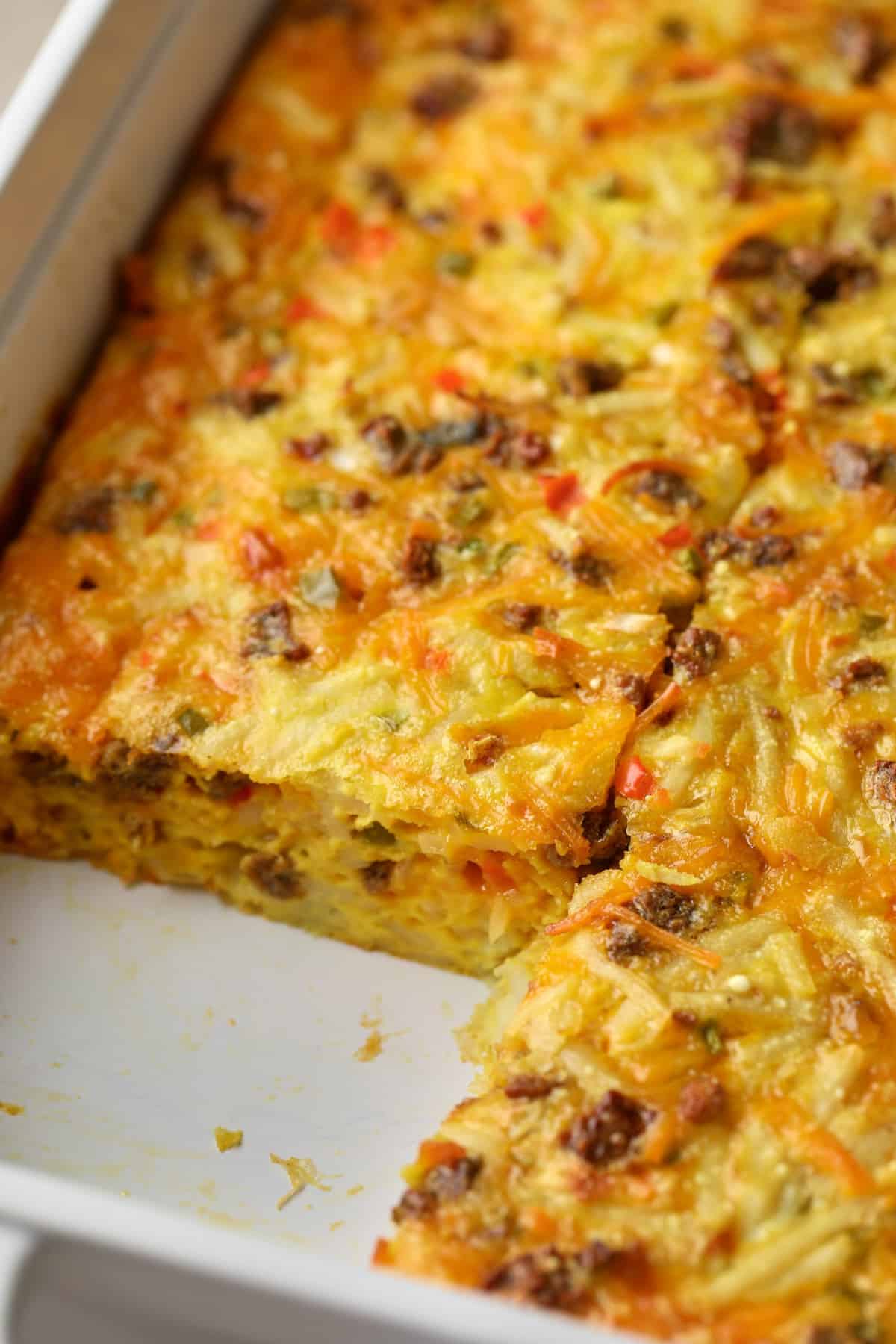 a sliced vegan breakfast casserole in a baking dish.