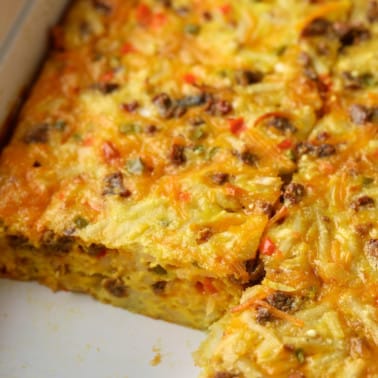 close up on a sliced Vegan Breakfast Casserole in a baking dish.