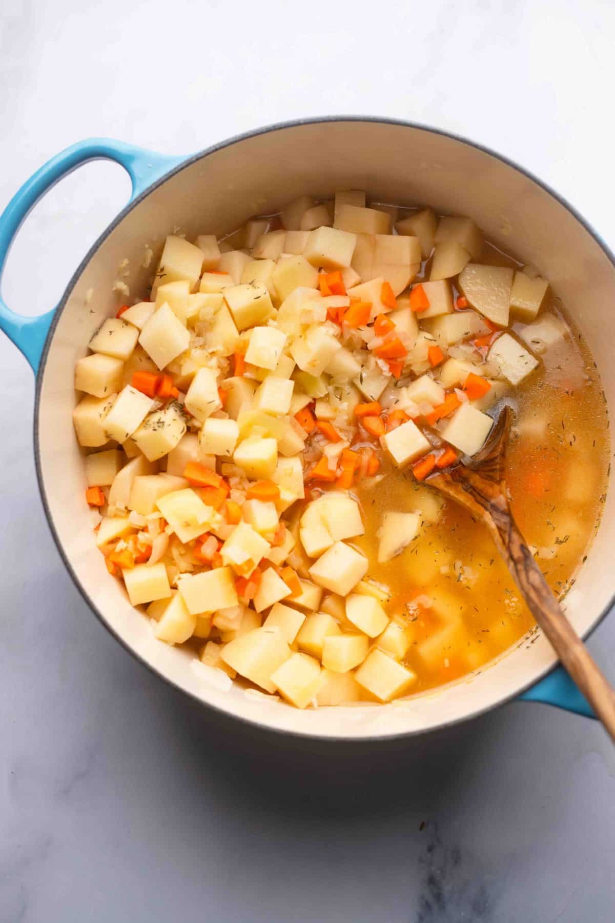 potatoes, carrots and broth in a pot