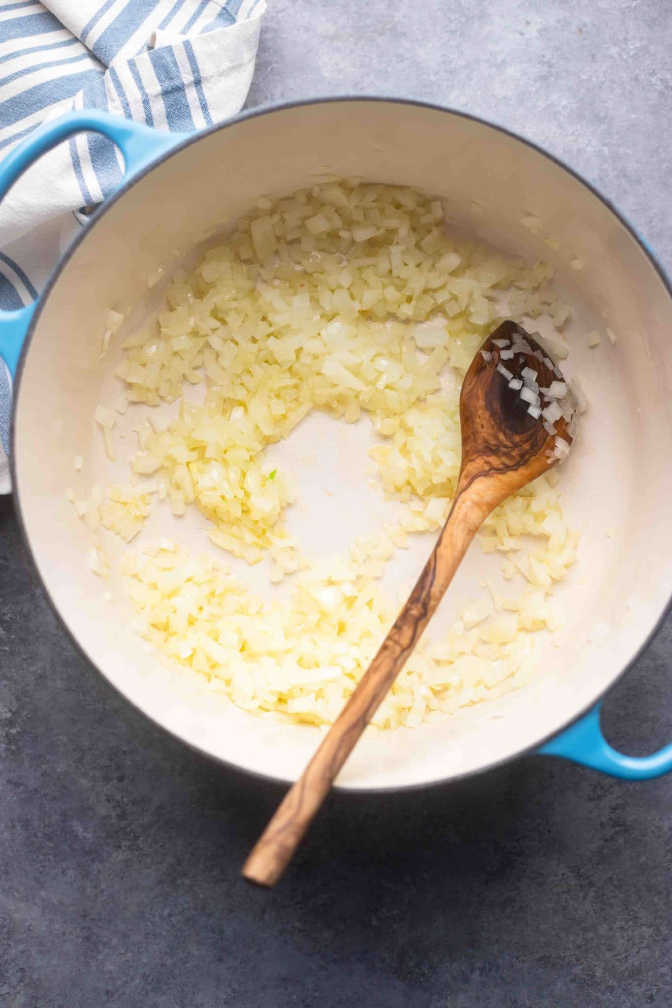 cooking chopped onions in a large pot.