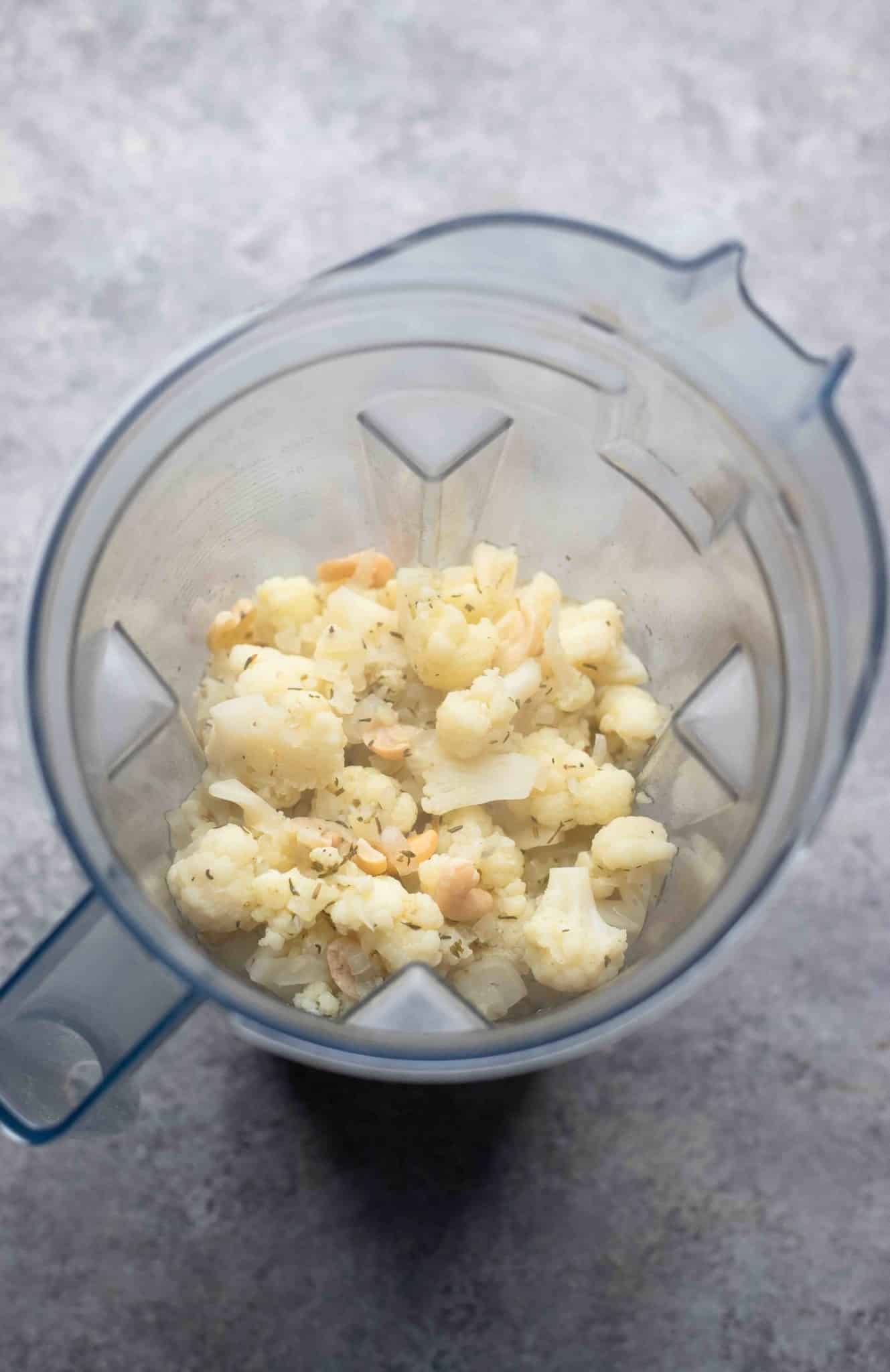 the cooked ingredients for vegan cauliflower soup in a blender.