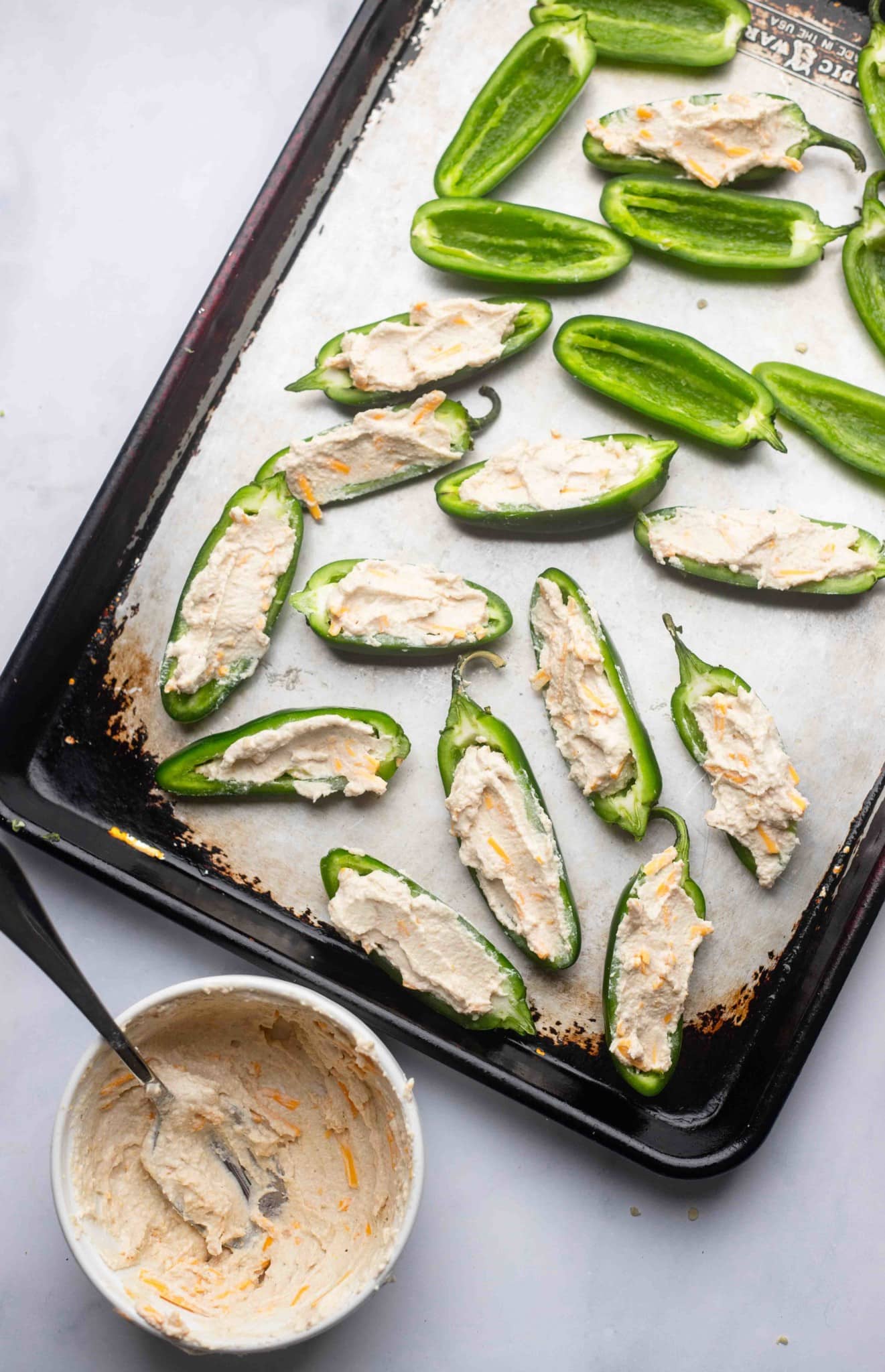 stuffing halved jalapeno peppers with a cream cheese mixture.