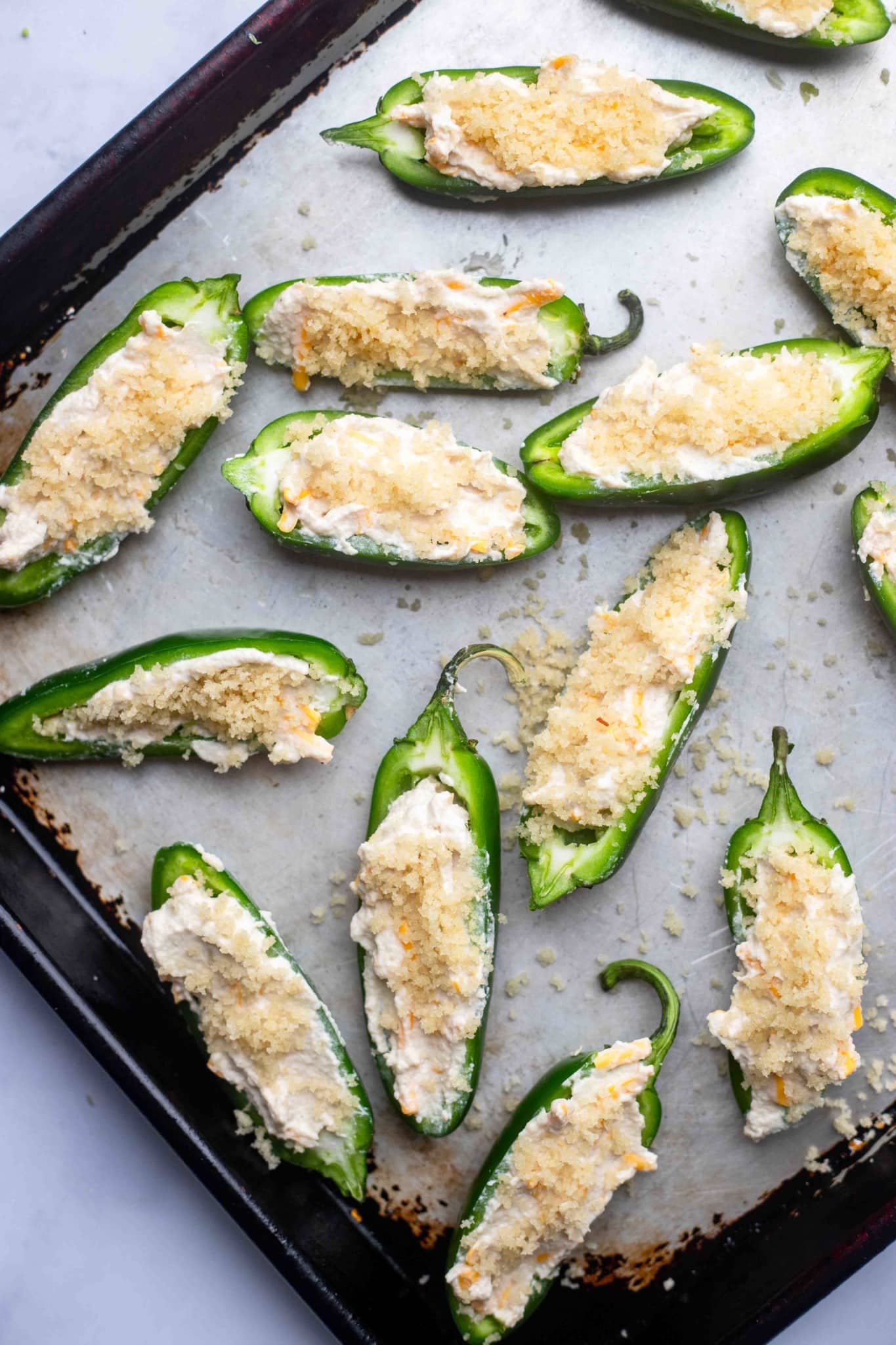 unbaked Vegan Jalapeno Poppers on a baking sheet.