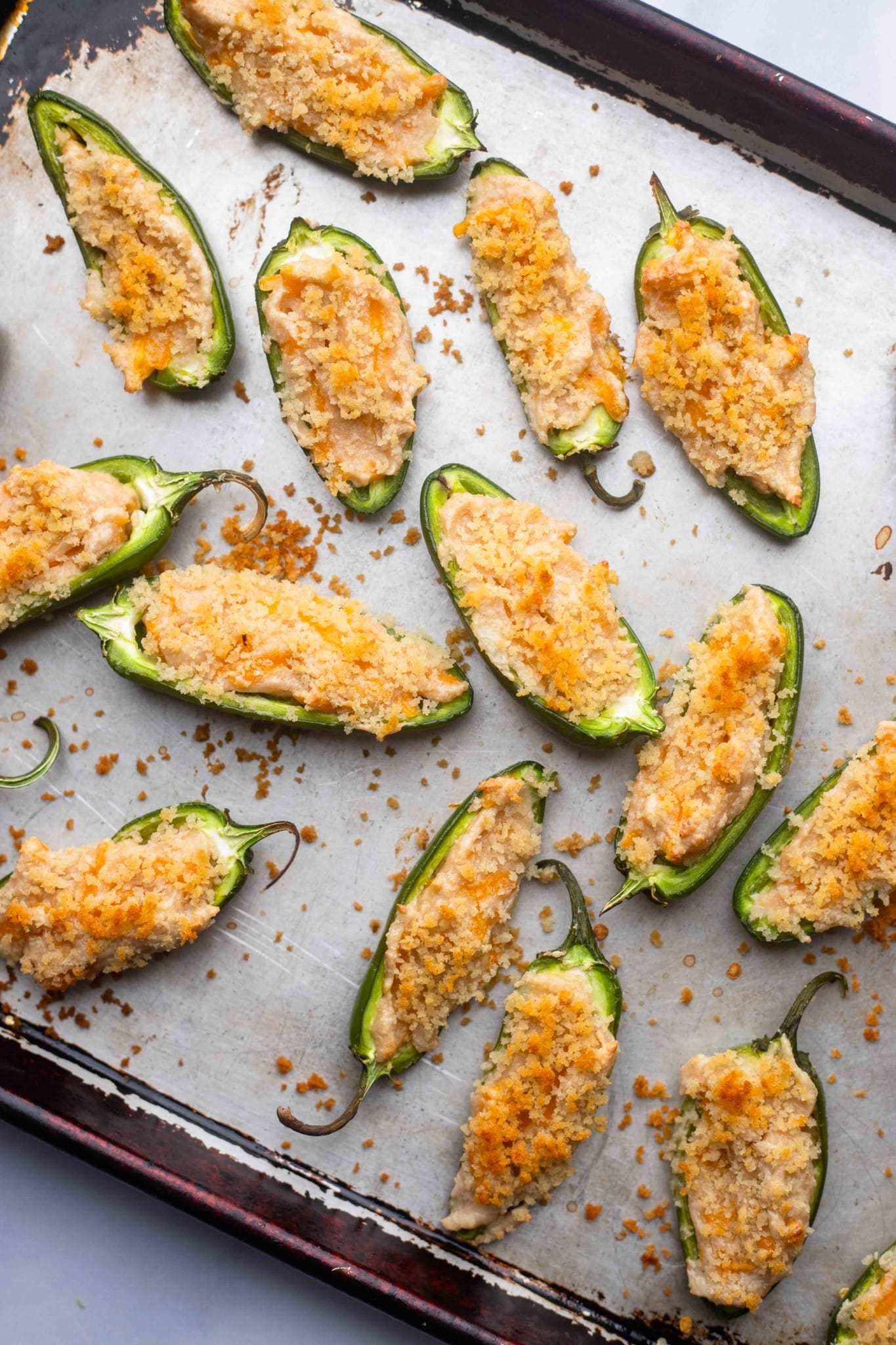 baked Vegan Jalapeno Poppers on a baking sheet.