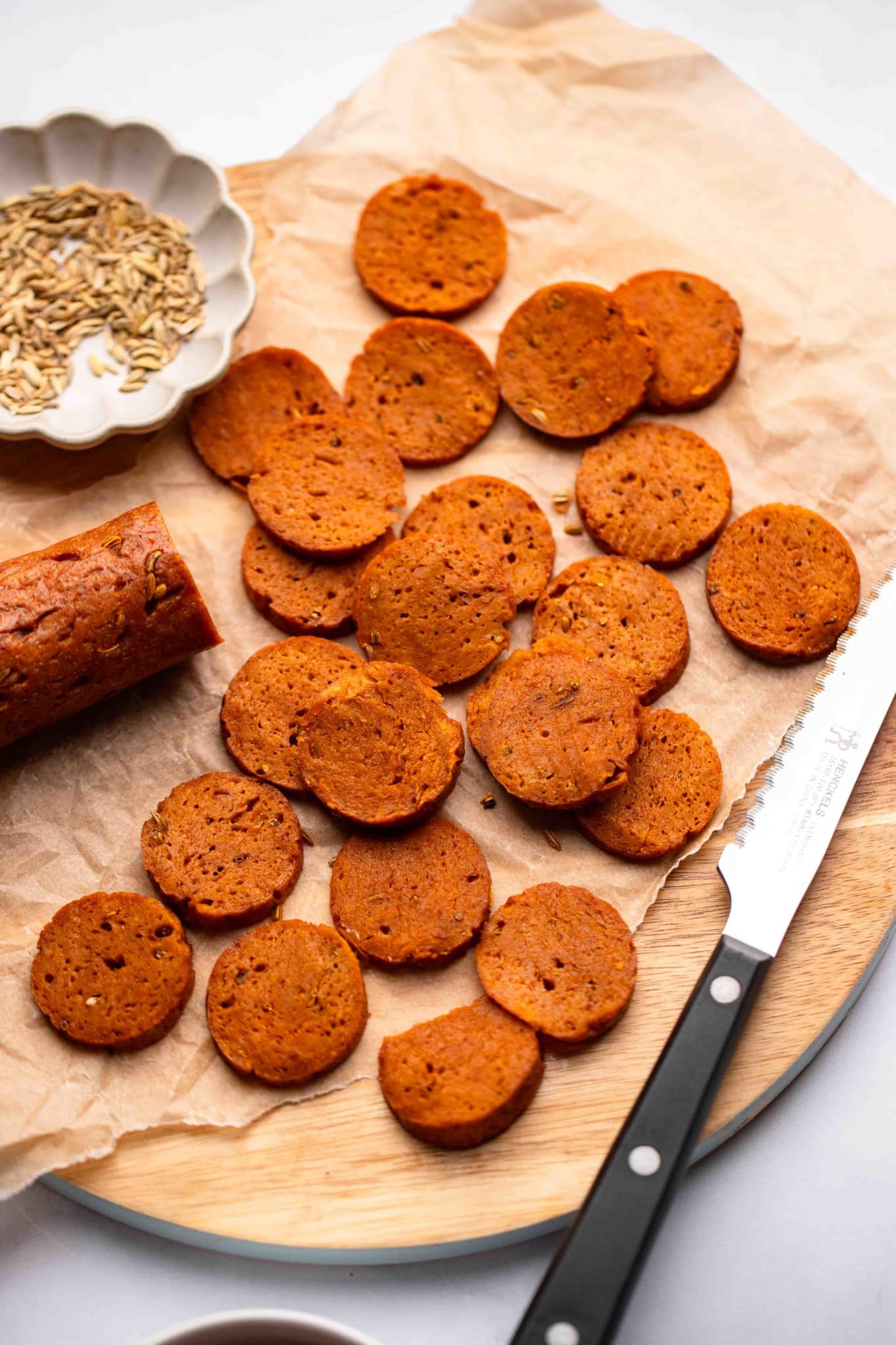 sliced vegan pepperoni on a wood board.