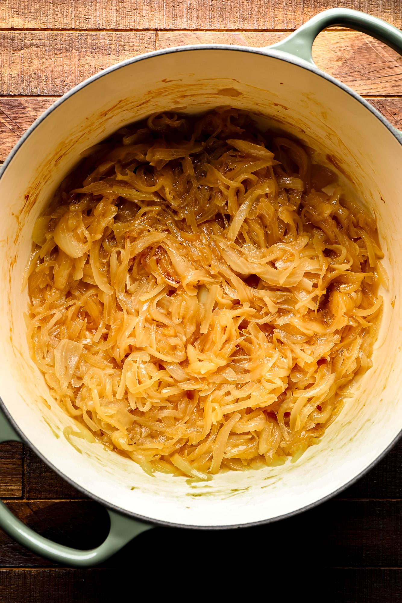 cooking sliced golden onions in a large pot.