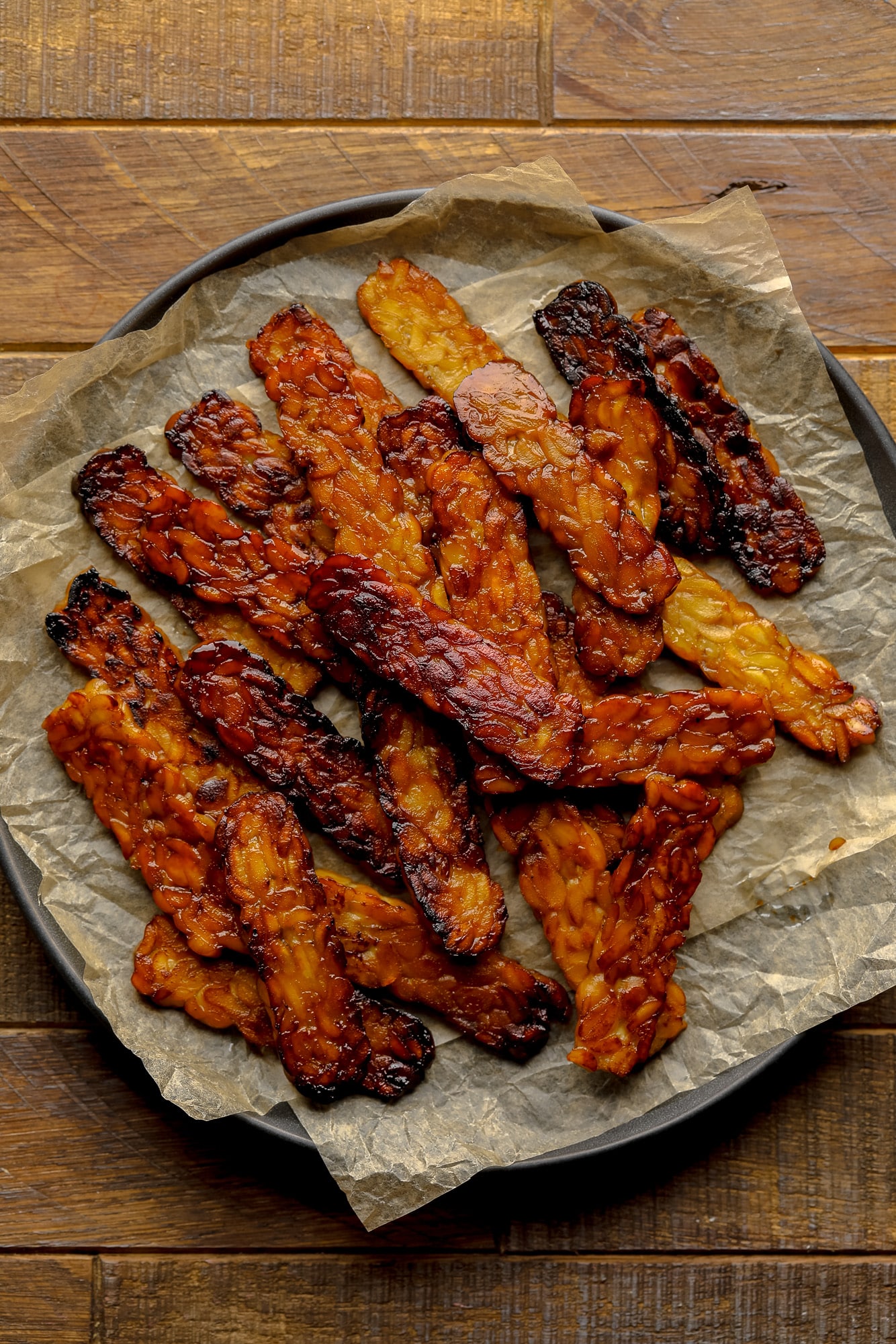 a pile of pan-fried tempeh bacon slices.