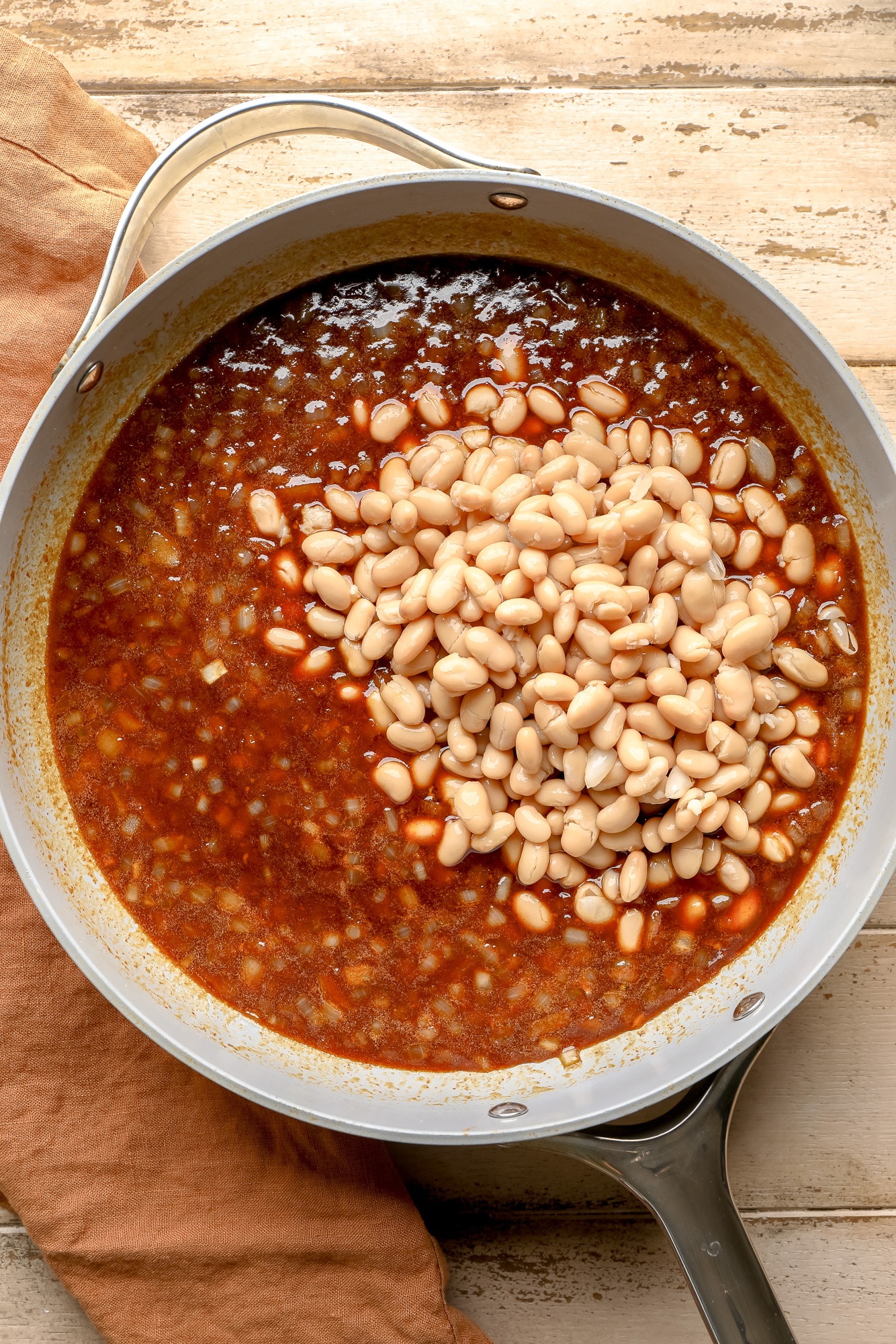 white beans and a baked bean sauce in a skillet.