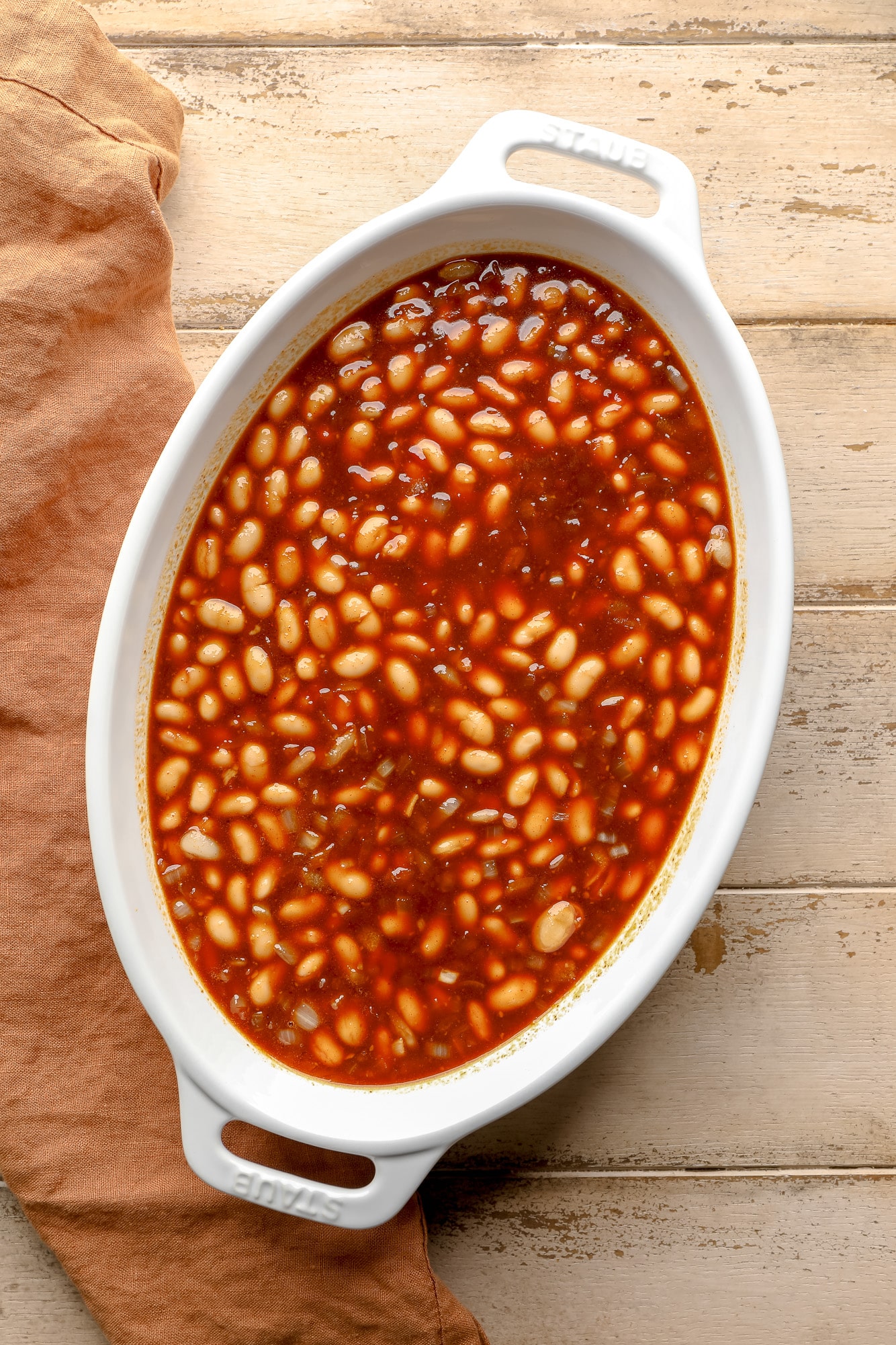 uncooked vegan baked beans in a casserole dish.