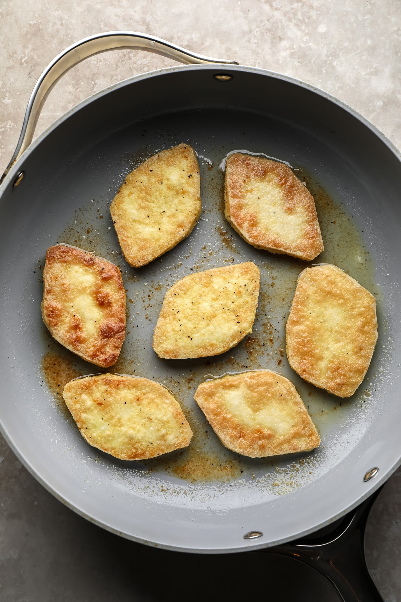 frying tofu pieces in a large skillet.